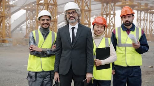 Diverse Group of People Building Team Standing Outdoors in Construction Site Smiling