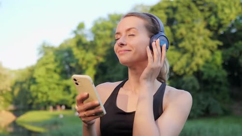 Woman Enjoying Music in the Park