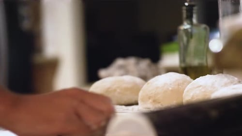 Dough Balls being Kneaded in a Kitchen