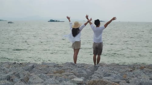 Couple Celebrate on Rocky Ocean Beachfront