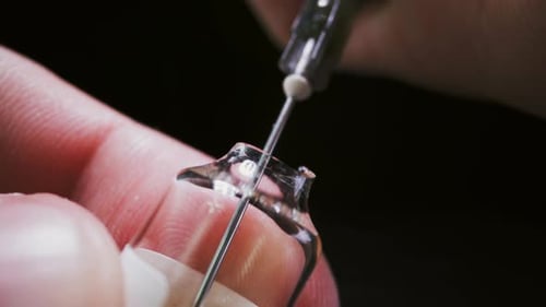 Macro Shot of Vial with Needle and Liquid