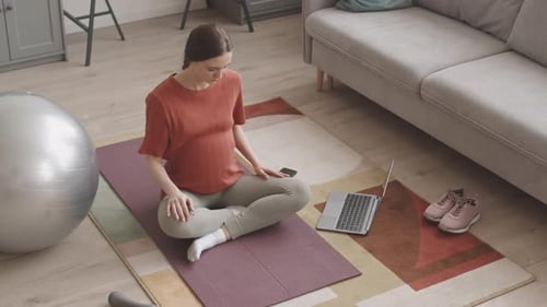 Woman Practices Yoga at Home