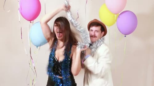 Happy couple having great time dancing in photo booth