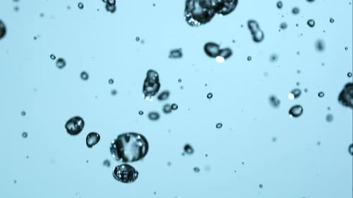 Rising Water Bubbles Against Light Blue Background