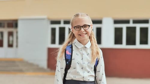 Portrait of Smiling School Girl Child with Backpack.
