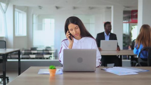 Young Manager Consulate Client in Open Space Office Worker in Start Up Compan