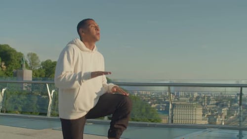 Young Man Stretching on Urban Pedestrian Bridge
