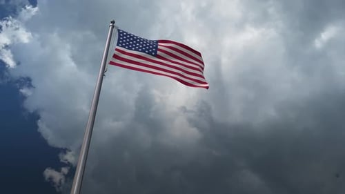 Waving American Flag on Pole with Dynamic Clouds