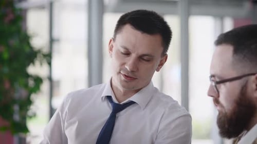 Two Men Discussing in Modern Office Environment