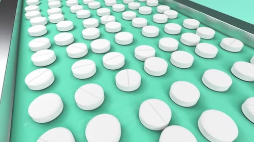 White Pills on the Conveyor Line of Pharmaceutical Factory Moving for Packaging