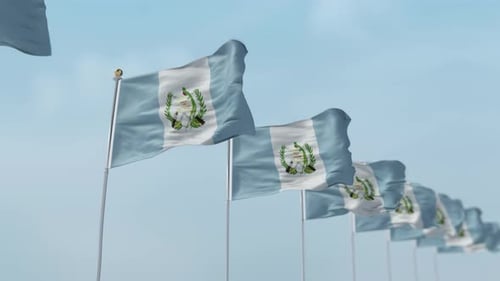 Multiple Guatemala Flags Waving in a Row Against Blue Sky