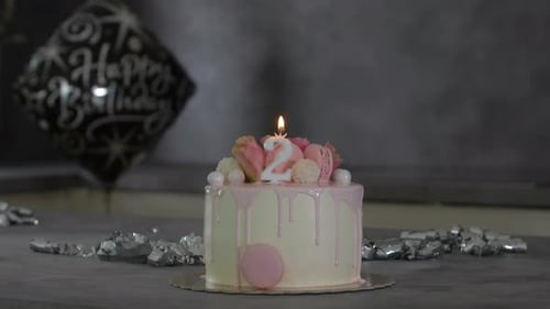Sweet Decorated Birthday Cake With Candle and Balloon