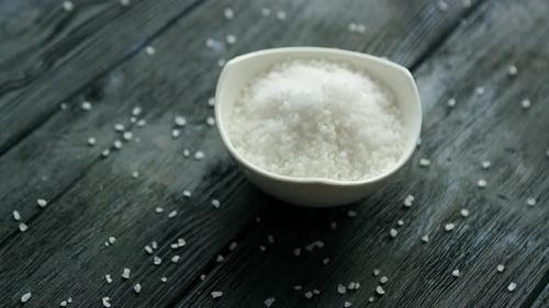 Coarse Sea Salt in White Bowl on Wood