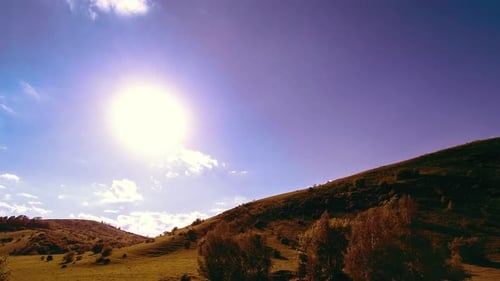UHD Mountain Meadow Timelapse at the Summer. Clouds, Trees, Green Grass and Sun Rays Movement.
