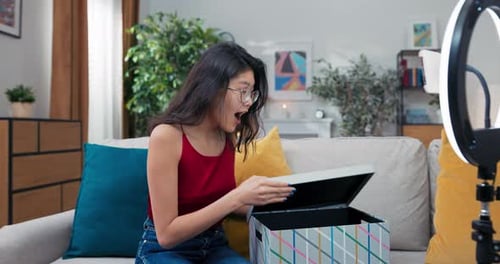 Woman Opens Box With Ring Light