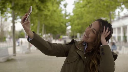 Woman Smiling and Posing in a Sunny Park