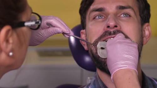 Man Receiving Dental Care at Dentist Office