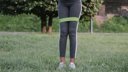 Woman Exercising Outdoors with Resistance Band