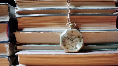 Antique Pocket Watch Resting on Stack of Books