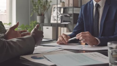 Adults Meeting in Office Discussing Budget
