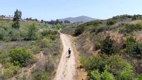 Aerial View of Riding Mountain Bike in a Small Singletrack Trail in the Mountain