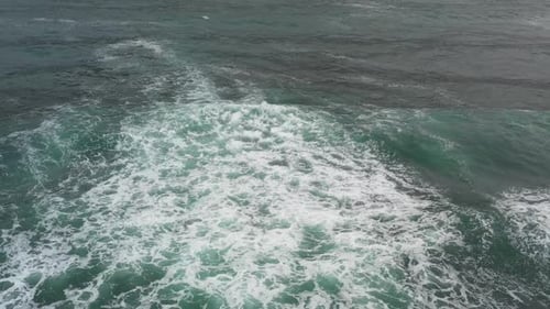 Aerial top view of rocks in the sea - Aerial video of majestic waves splashin