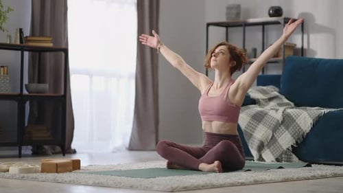 Young Woman Practicing Yoga at Home