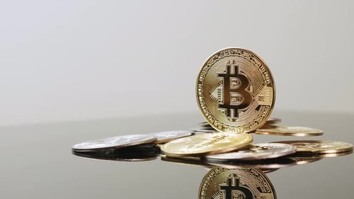 Bitcoin Cryptocurrency Coins on Reflective Surface