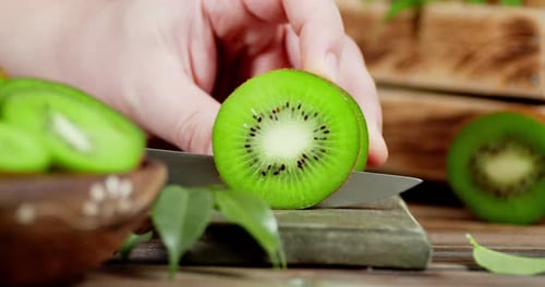Slicing Fresh Green Kiwi Fruit at Home