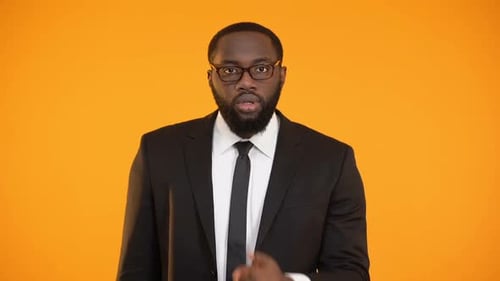 Man in Suit Gestures for Silence