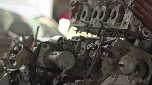Car Mechanic Removes Valve Cover Of Broken Car Engine In Workshop