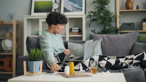 Woman Uses Laptop While Sick at Home