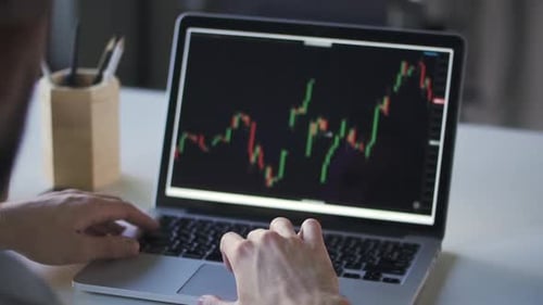 Young Businessman Working is with Laptop While Sitting at Table in Modern Office
