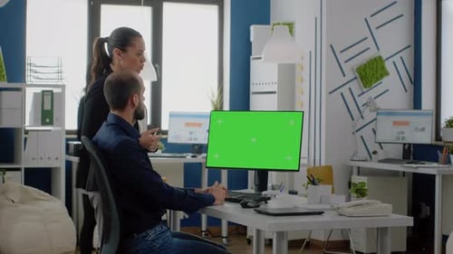 Colleagues Using Horizontal Green Screen on Computer