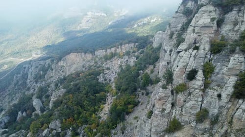 Aerial Footage Above a Foggy Mountain During Fall Season