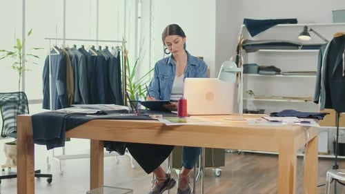 Successful Businesswoman Tailor Girl Works with Sketches of Clothes