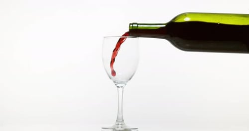 Red Wine being poured into Glass, against White Background, Slow motion 4K