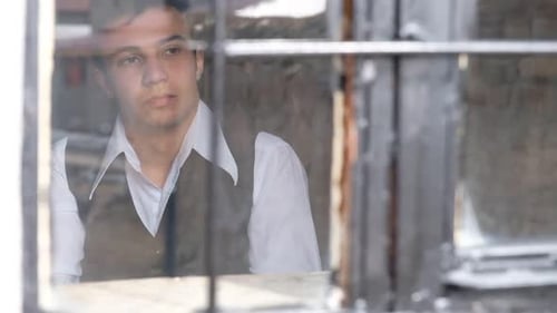 Man Looking Through Glass Window Pane