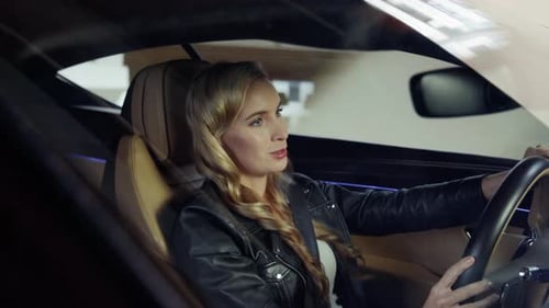 Woman Driving Car in Underground Parking Garage