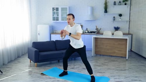 Man Doing Side Lunges on Yoga Mat at Home