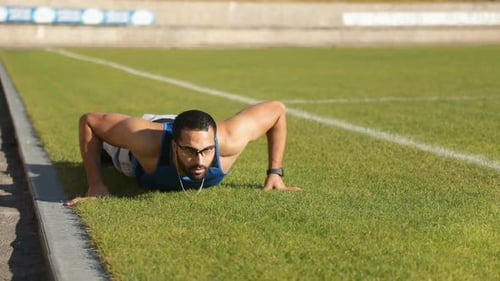Man Exercising Doing Pushups on Grass Field
