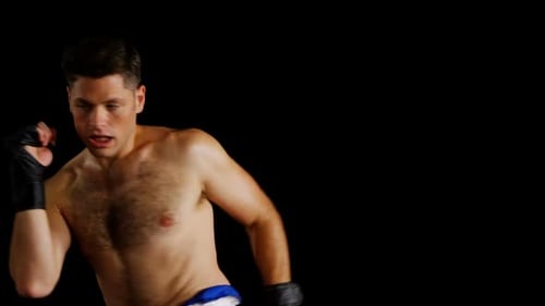 Shirtless Man Practicing Muay Thai Boxing