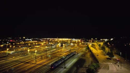Aircraft following train leaving Malmö at night