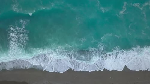 Aerial Top View Turquoise Sea Waves Break on Empty Sand Beach, Clean Sea Waves From Bird's Eye View