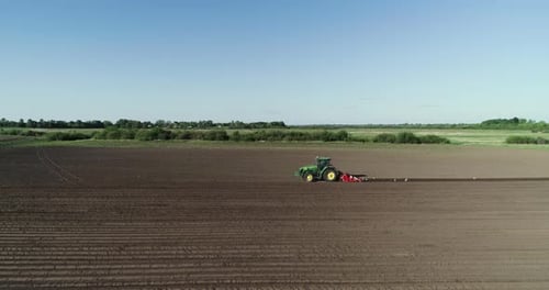 Tractor With A Plow Plowing In The Field