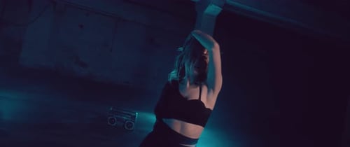 Female Dancer in a dark Parking Lot with Neon Lights