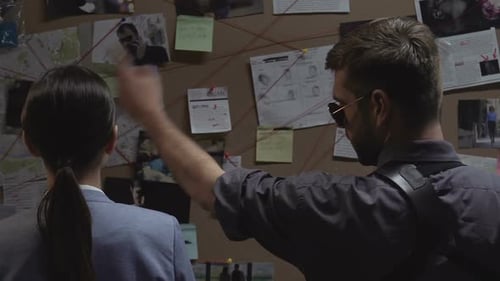 Detectives Reviewing Evidence Board in Office