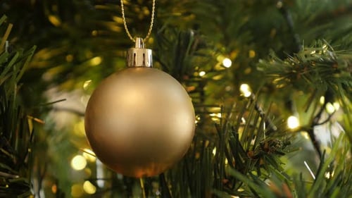Close-up of golden Christmas ornament 4K 2160p 30fps UltraHD footage - Gold color bauble on the tre