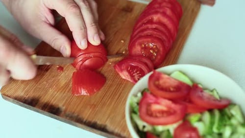 Male Hands Citting Tomato for Salad. Close Up.