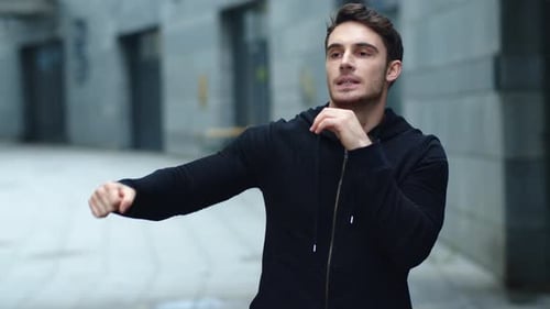 Young Adult Stretching Arms Before City Workout